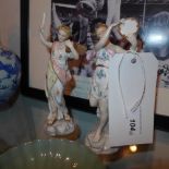 A pair of fine Continental porcelain figures one holding a tamborine the other a book