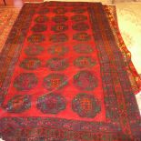A fine North East Persian Turkoman carpet, 275cm x 165cm, repeating goul motifs on a rouge field