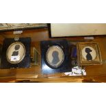 A collection of framed silhouettes in ebonised frame