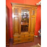 A late C19th walnut wardrobe the single mirrored door enclosing hanging space above four drawers