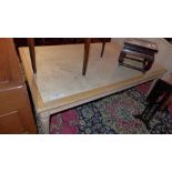 A contemporary low table the large rectangular granite top raised on reeded supports