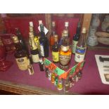 A collection of various whiskeys and other spirits and liqueurs and a packet of assorted similar