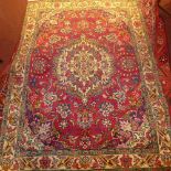 A fine North West Persian Tabriz rug, 195cm x 140cm, central pendant medallion on a rouge field