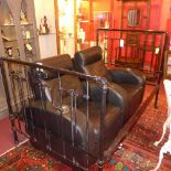 A late Victorian black painted cast iron bedstead