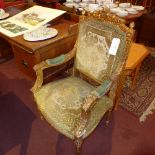 A pair of French carved giltwood armchairs upholstered in green floral fabric and raised on turned