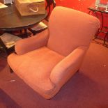 A pair of Howard style armchairs upholstered in mottled fabric raised on castors