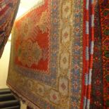 A hand knotted Kazak rug the red field having multicoloured motifs in a triple border 183 x 124 cm