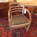 A set of four oak Utility style chairs including two carvers with drop in seats upholstered in