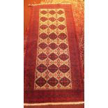 A fine North East Persian Meshad Belouch rug, 230cm x 110cm, repeating panel motifs within stylised