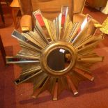 An Art Deco style sunburst form mirror in gilded frame