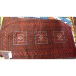 A fine North East Persian Turkoman rug, 195cm x 115cm, triple goul motifs on a rouge field within
