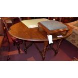 WITHDRAWN A 1940's oak drop flap dining table raised on barley twist gateleg supports
