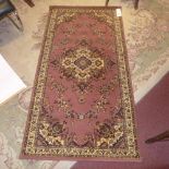 A Persian style rug the dark brown ground having floral medallion and floral patterns in triple