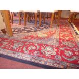 A large Persian style carpet with central lozenge medallion on the blue field with extensive floral