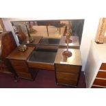 A 1960`s Stag walnut dressing table with mirror back above arrangement of seven drawers
