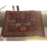 A hand woven Bakhtiari Persian carpet, the field with polychrome compartments enclosing floral