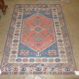 A hand knotted Turkish rug the blue and red fields with geometric decoration
