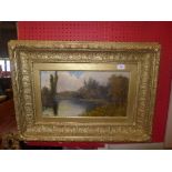 An oil on canvas of a lake scene within gilt frame signed L. Edgar