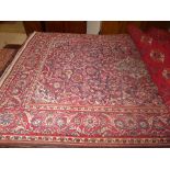 A Kashan rug with an ivory and madder lobed pole medallion enclosed by similar spandrels and