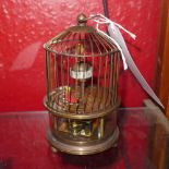 A novelty desk clock in the form of a birdcage with moving birds