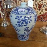 A Chinese blue and white baluster form vase decorated with flowers