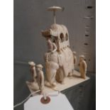 An early C20th ivory carving of an Indian elephant mounted with important figures, with four