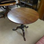 A George III mahogany tilt top tea table the circular top on tripod base