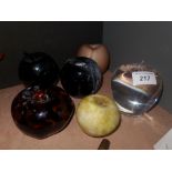 A collection of six glass apple paperweights