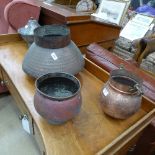 A group of small copper squat pots, one with lid