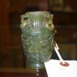 A translucent spinach green jade Koro with three ring handles decorated with mythical faces