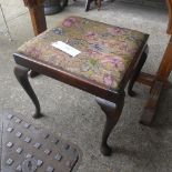 A stool with needle work seat on cabriole supports