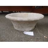 A pair of reconstituted stone trough form planters