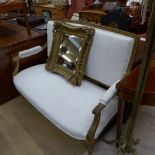 A carved giltwood canape upholstered in cream fabric having acanthus leaf scroll arms and