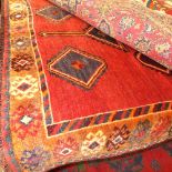 A fine South West Persian Lori carpet (280 cm x 160 cm) central pendant medallion on a terracotta