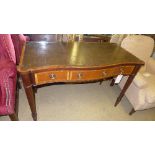 A mahogany Serpentine desk with tooled green leather top on tapered supports