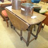 A C19th gateleg table the twin oval flaps on bobbin supports
