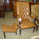 A Victorian style mahogany library armchair upholstered in button tan leather raised upon turned
