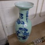 An Oriental style vase with blue decoration on a celadon ground