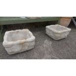 A pair of reconstituted stone planters