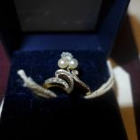 An 18ct gold ladies ring set diamond with two pearls below on a scrolling setting with diamond ring
