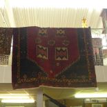 A fine North West Persian Heriz carpet repeating geometrical motif on a terracotta field within