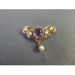 A 9ct gold amethyst butterfly form brooch having central claw set stone with twin pearls to either