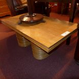 An oak low table raised on bamboo suppor