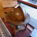 A Globe form drinks cabinet raised on ba