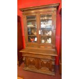 A Victorian carved oak bookcase fitted p