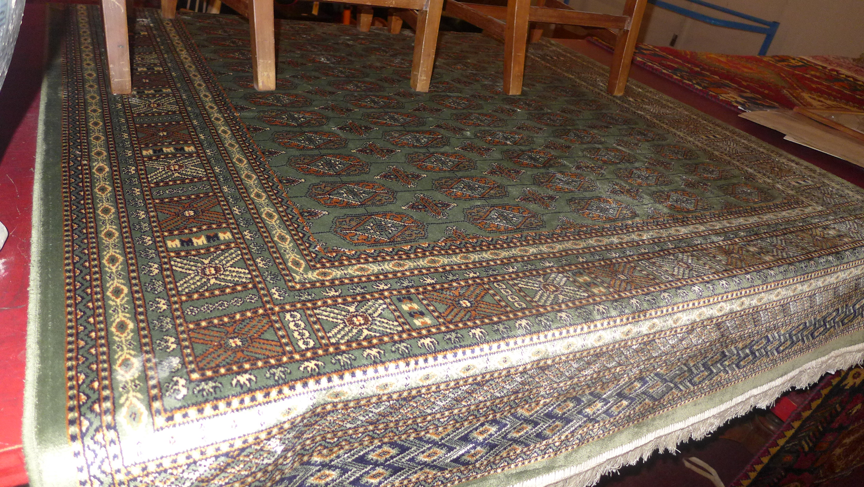 A Persian Bokhara style rug the green fi