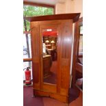 An Arts and Crafts inlaid oak wardrobe a