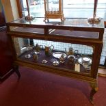 A 1920's oak shop display cabinet having