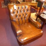 A pair of club chairs upholstered in tan