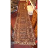 A hand knotted Persian Heriz runner the biege ground having repeating geometric patterns